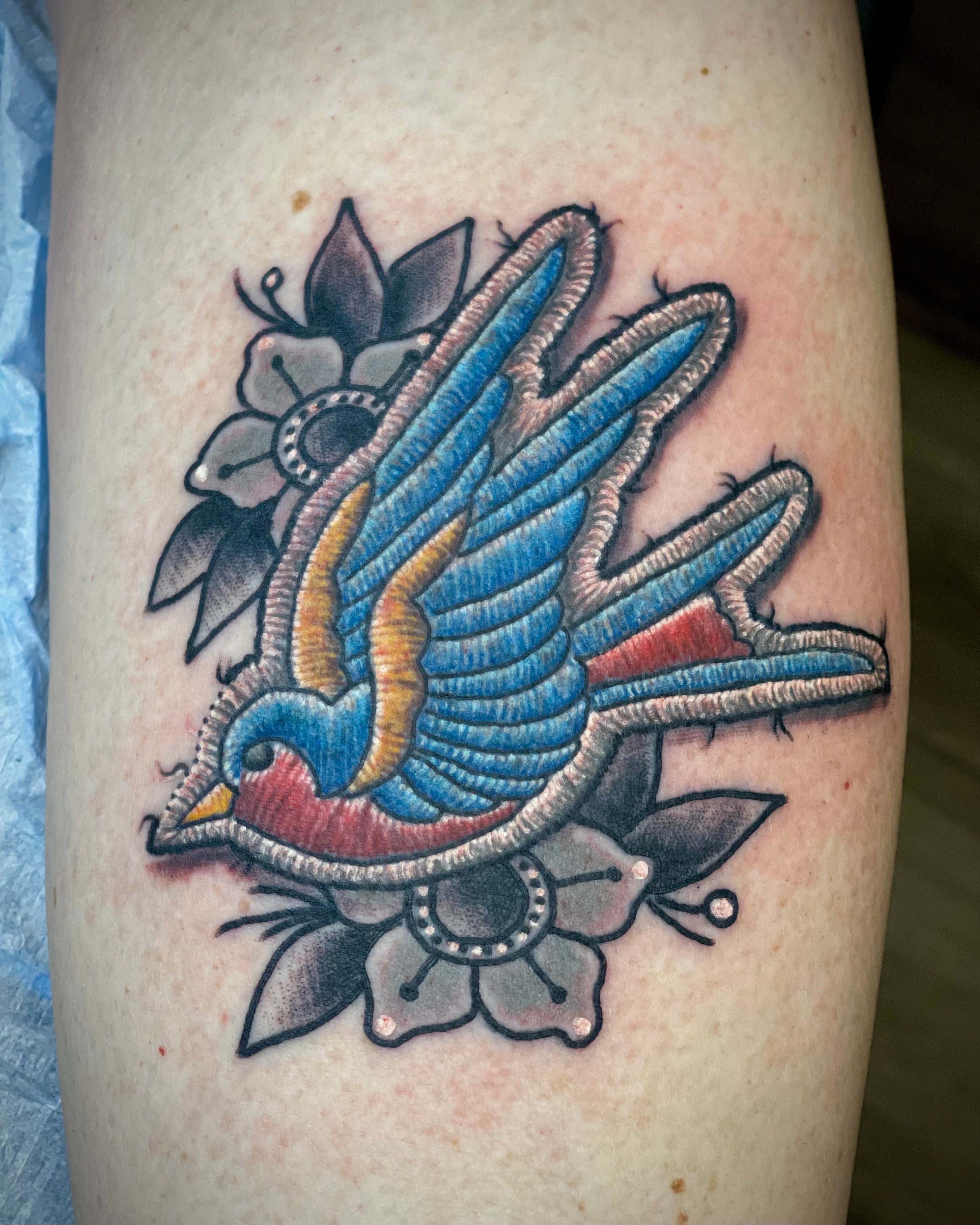 bird patch grey flowers tattoo
