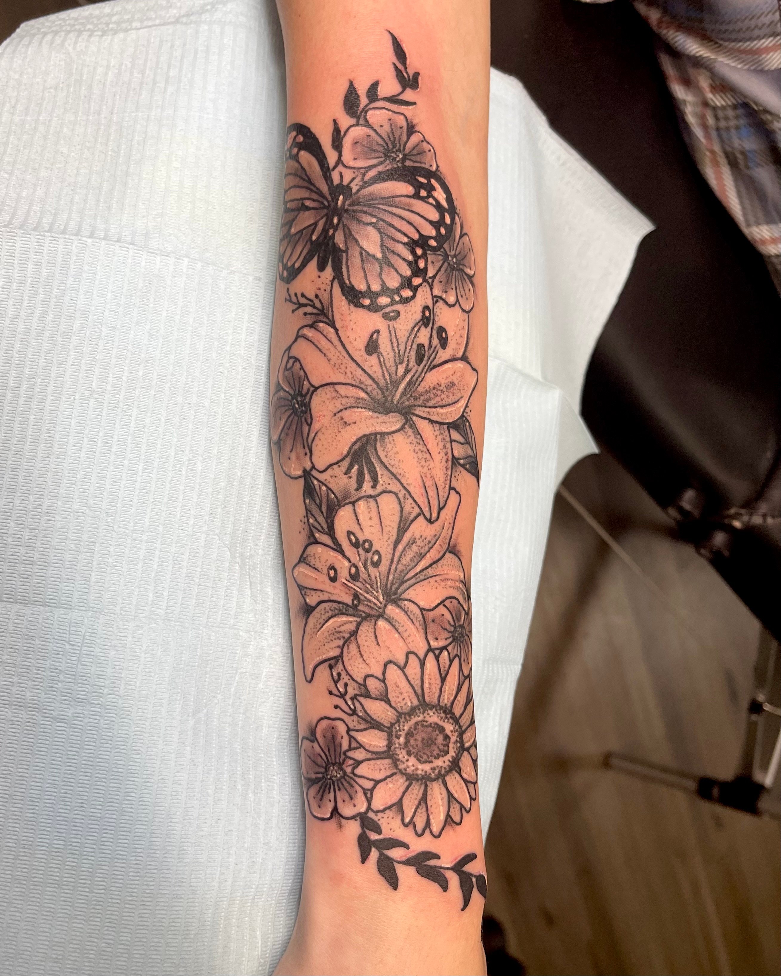 black and grey flower sleeve tattoo