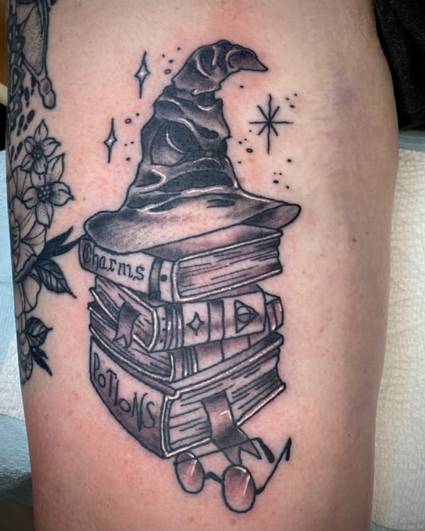 harry potter tattoos - sorting hat and spell books tattoo