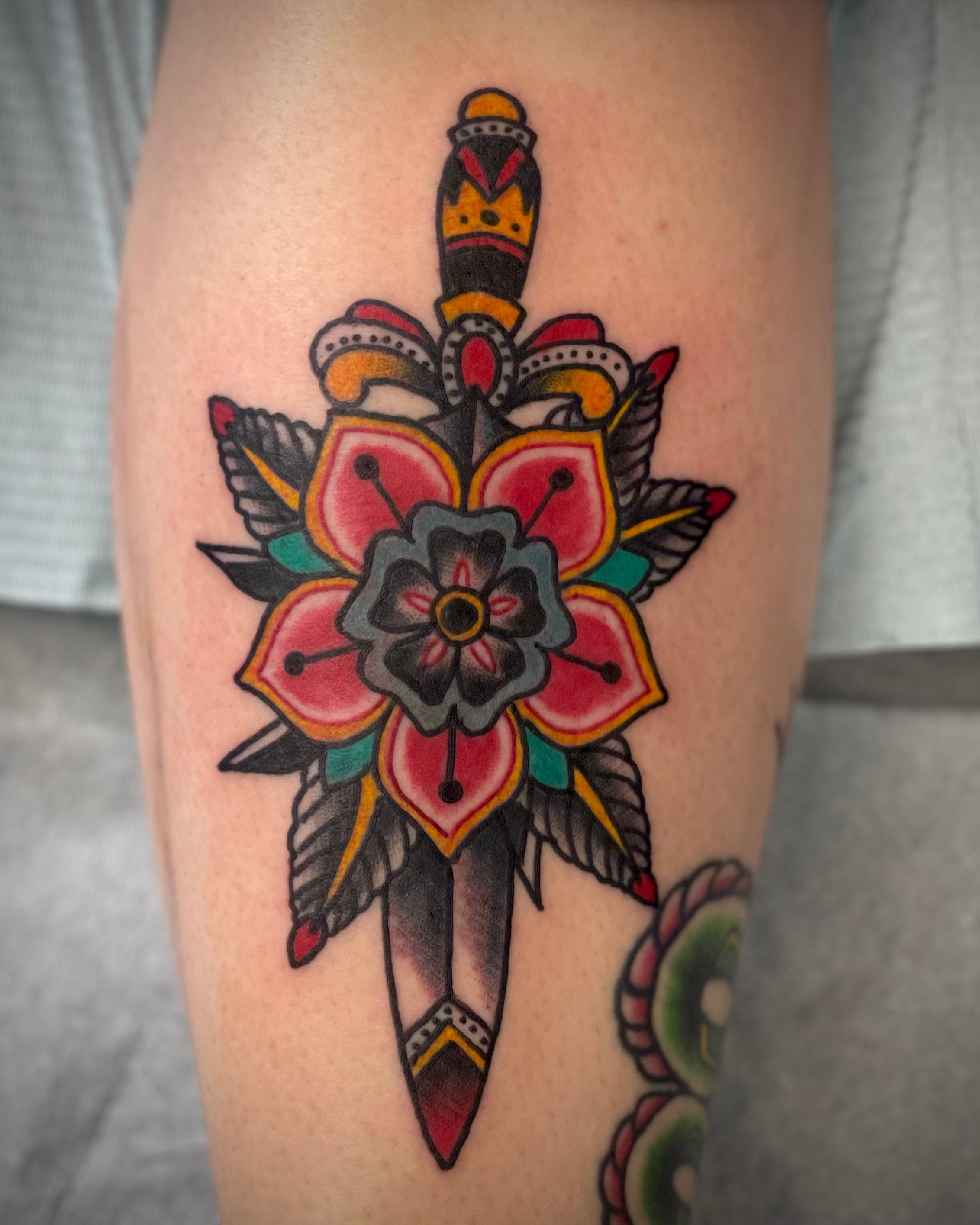 traditional flower and dagger tattoo