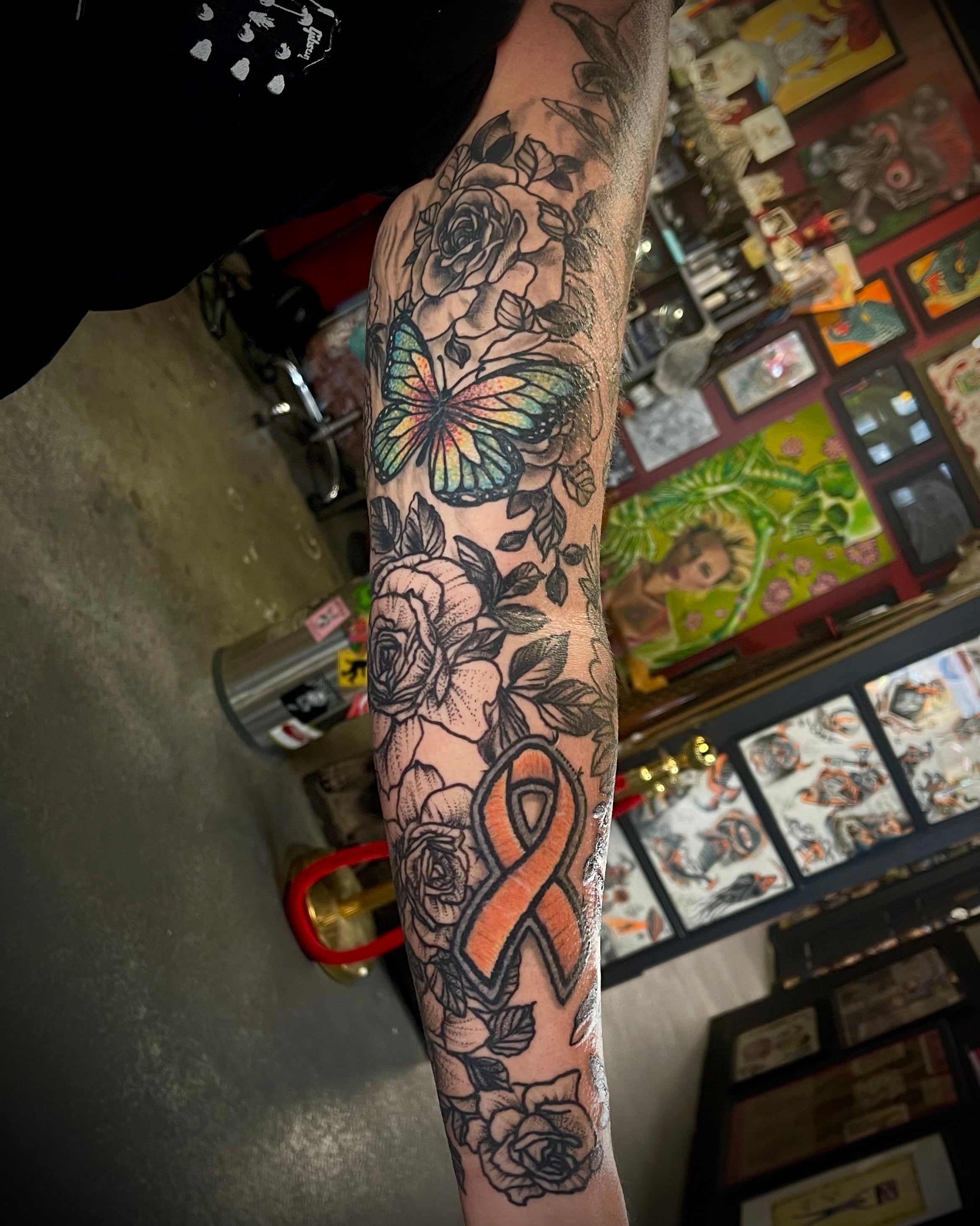 Floral Sleeve Tattoo with Butterflies and Cancer Ribbon