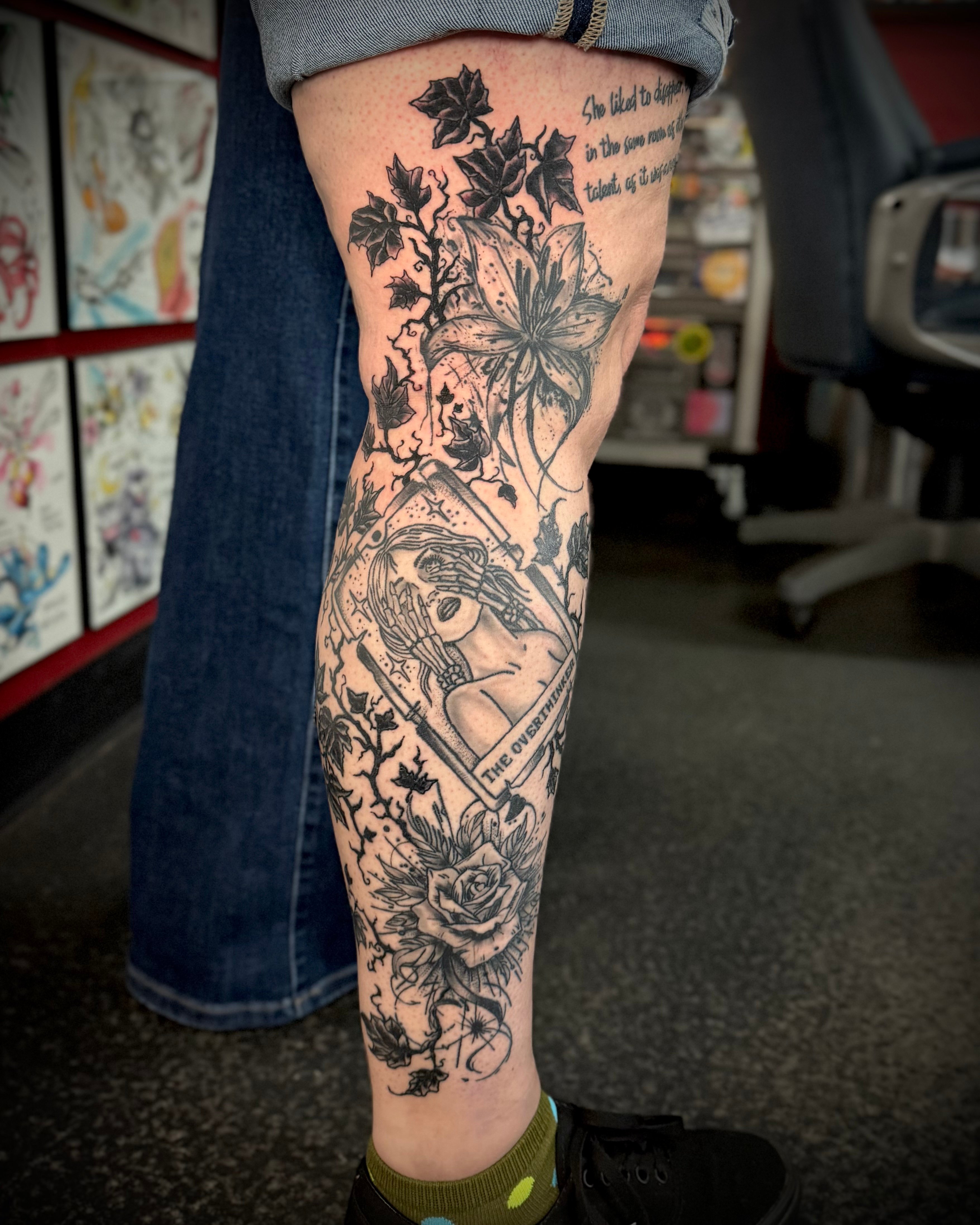 Dark themed leg tattoo