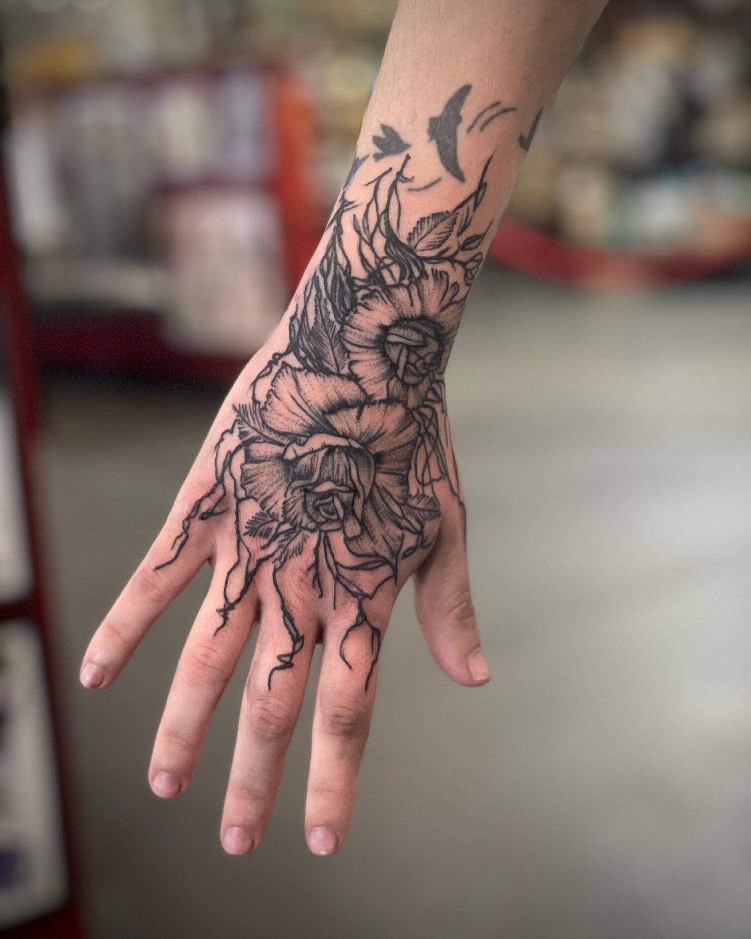 Distressed Flower on Hand tattoo